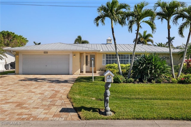 ranch-style home with a front yard and a garage