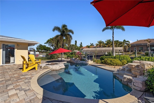 view of swimming pool with a patio area