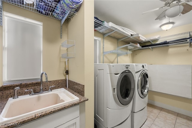 laundry room featuring light tile patterned flooring, separate washer and dryer, sink, and ceiling fan