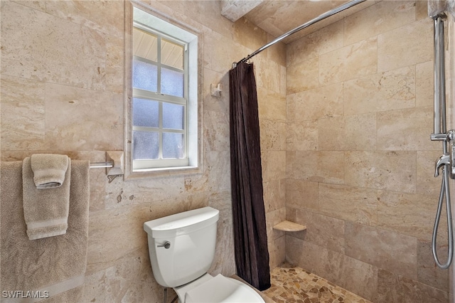 bathroom with toilet and curtained shower