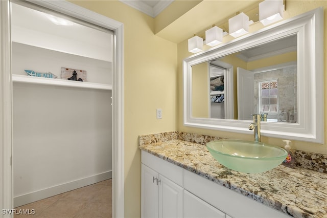 bathroom featuring vanity, crown molding, and tile patterned floors