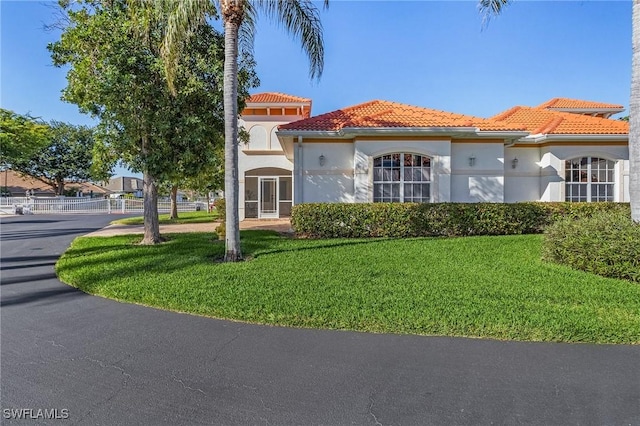 mediterranean / spanish-style house with a front yard