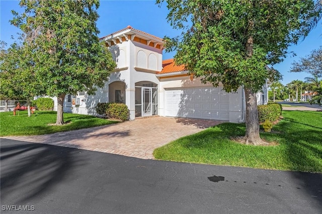 view of front of property with a garage and a front lawn