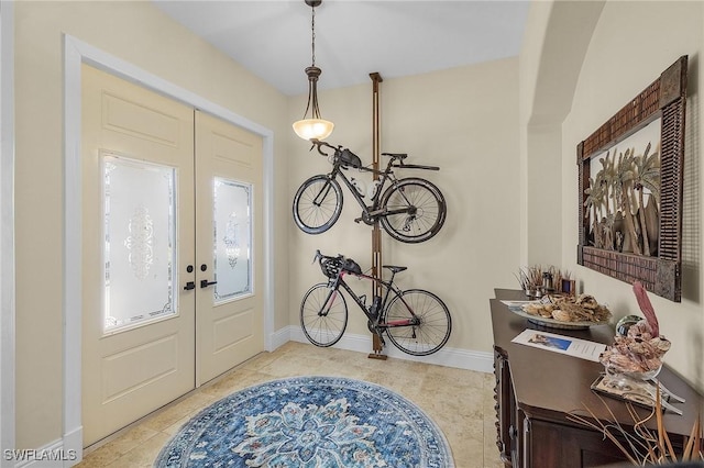 foyer entrance with french doors and light tile patterned flooring