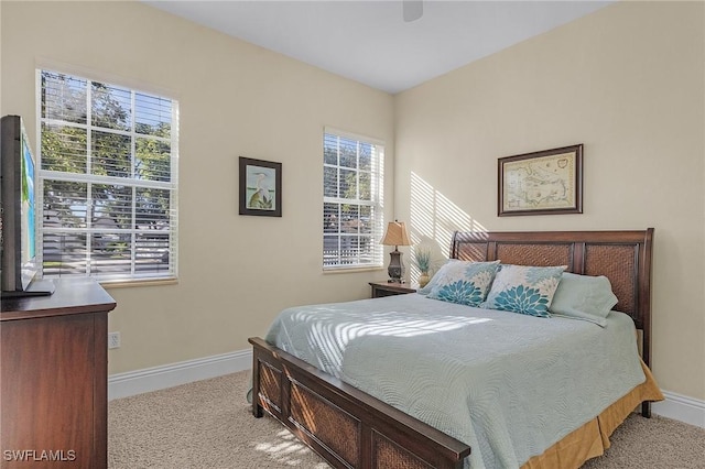 bedroom featuring light carpet and ceiling fan