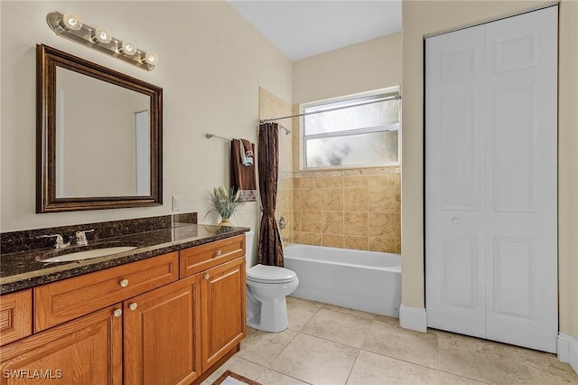 full bathroom featuring tile patterned flooring, shower / tub combo with curtain, vanity, and toilet