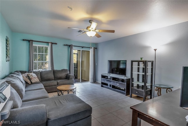 living room with ceiling fan and tile patterned flooring