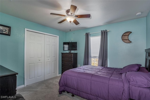 bedroom featuring ceiling fan, a closet, and light carpet