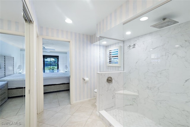 bathroom featuring tile patterned flooring, toilet, and tiled shower