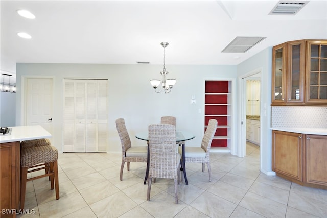 tiled dining area featuring a notable chandelier