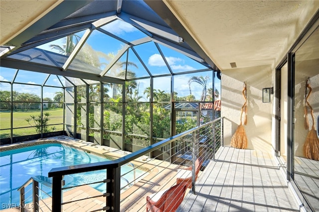 view of swimming pool featuring a lanai