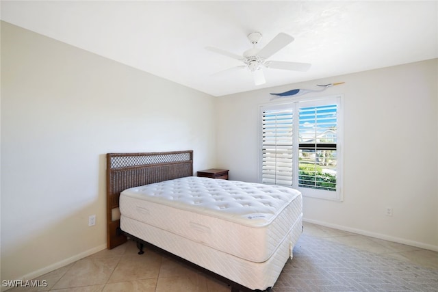 tiled bedroom featuring ceiling fan