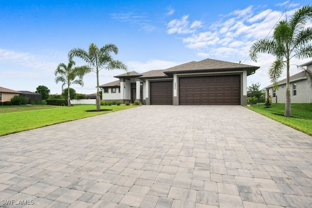 view of front of house with a front yard and a garage