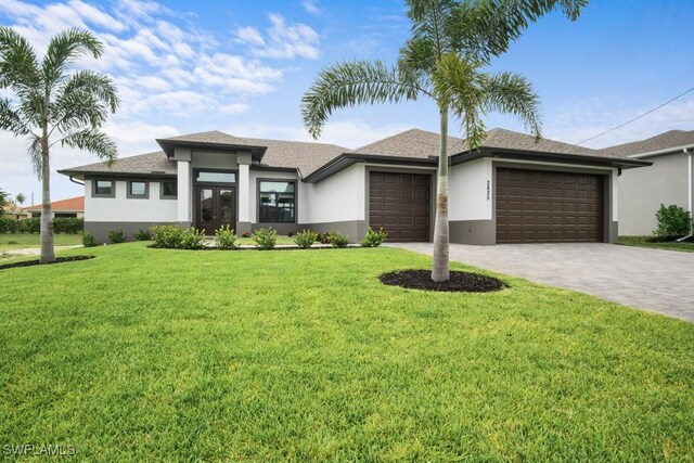 view of front of house featuring a garage and a front yard