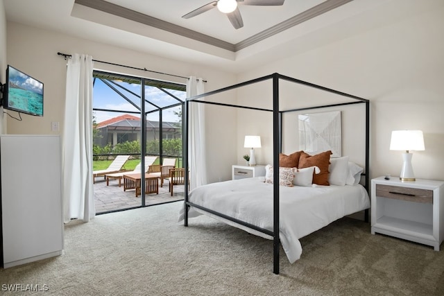 bedroom with ornamental molding, a raised ceiling, ceiling fan, and carpet