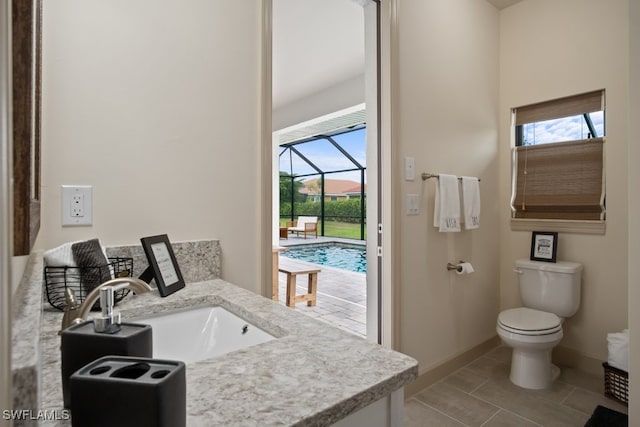 bathroom featuring vanity, tile patterned flooring, and toilet