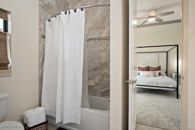 bathroom with shower / bath combination with curtain, ceiling fan, and toilet