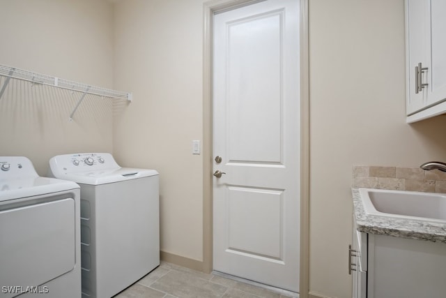 laundry room with cabinets, sink, light tile patterned floors, and independent washer and dryer