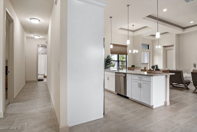 kitchen featuring white cabinetry, hanging light fixtures, stainless steel dishwasher, ornamental molding, and light stone countertops