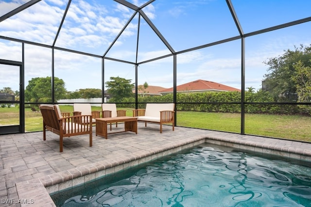 view of swimming pool featuring a yard, glass enclosure, and a patio area