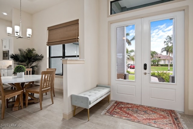 doorway to outside with an inviting chandelier and french doors