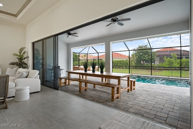 sunroom / solarium featuring ceiling fan and a swimming pool