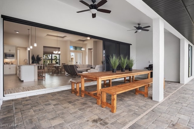 dining room with ceiling fan with notable chandelier