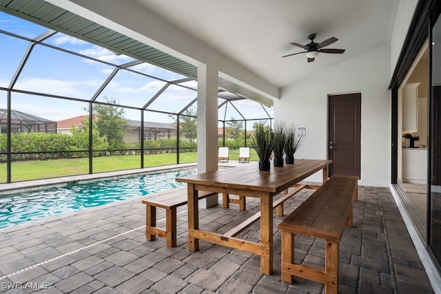 view of pool featuring ceiling fan, a lanai, and a patio area