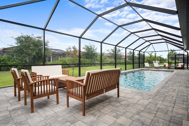 view of swimming pool featuring a patio, an outdoor hangout area, and glass enclosure