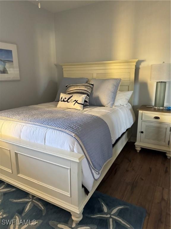 bedroom with dark hardwood / wood-style flooring