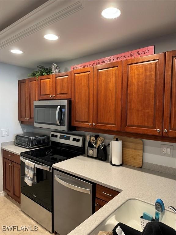 kitchen with light tile patterned floors and stainless steel appliances