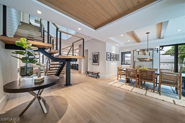 interior space with a wealth of natural light, light hardwood / wood-style floors, and wood ceiling