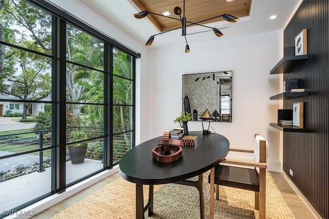 dining area featuring a chandelier and wood ceiling