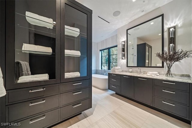 bathroom featuring a tub to relax in and vanity