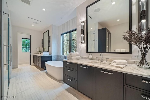 bathroom featuring vanity and a tub