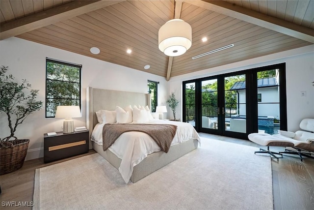 bedroom with access to outside, hardwood / wood-style flooring, french doors, and multiple windows