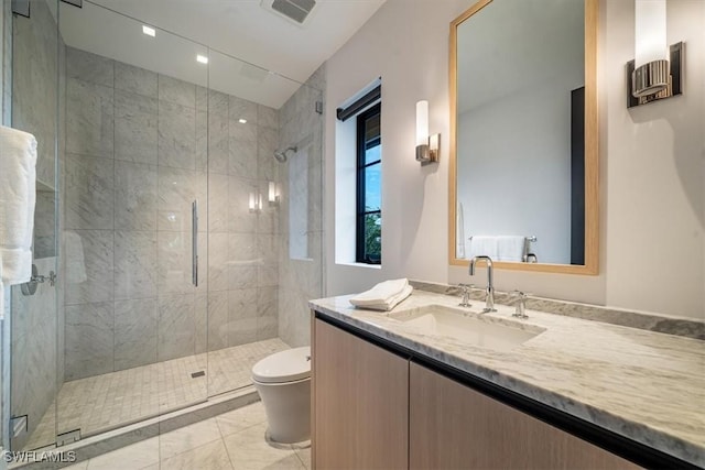 bathroom featuring toilet, vanity, tile patterned flooring, and walk in shower