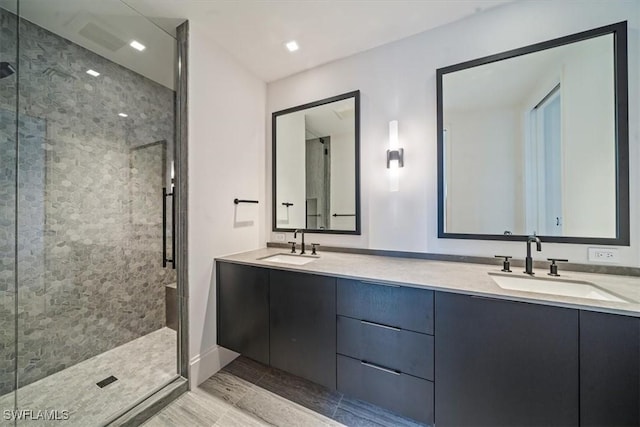 bathroom featuring a tile shower and vanity