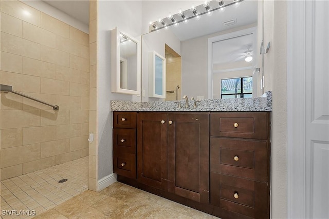 bathroom with vanity, tile patterned floors, and tiled shower