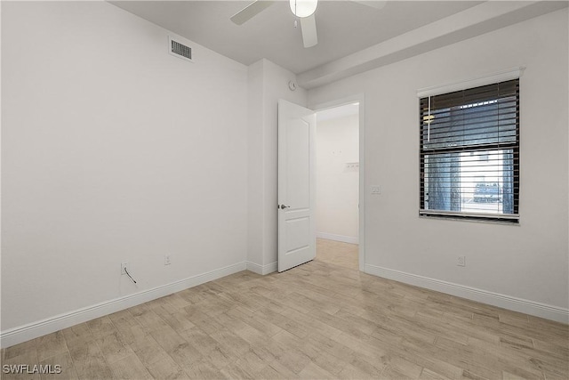 empty room with ceiling fan and light hardwood / wood-style floors