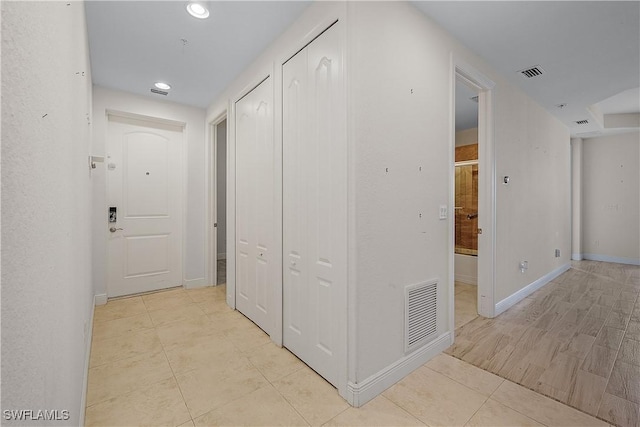 corridor featuring light tile patterned floors