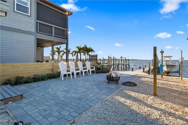 view of patio / terrace with a boat dock and a water view