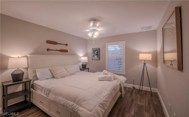 bedroom featuring ceiling fan and dark hardwood / wood-style floors