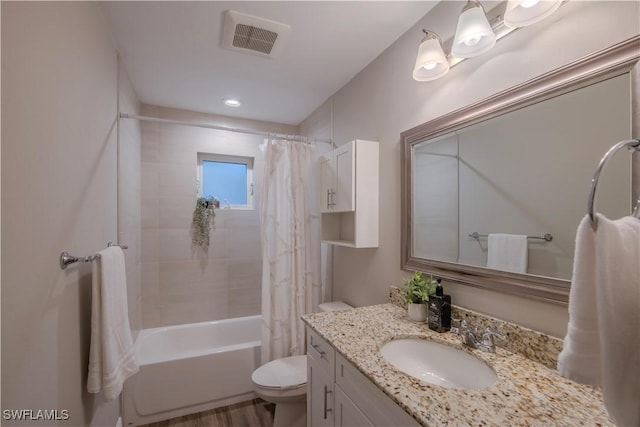 full bathroom with hardwood / wood-style floors, vanity, shower / bath combination with curtain, and toilet