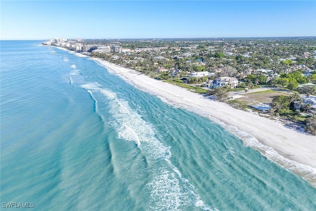 bird's eye view with a water view and a beach view