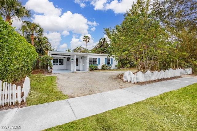 view of front of home with a front yard and a carport