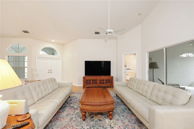 living area with visible vents, a ceiling fan, and wood finished floors