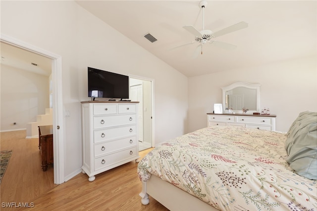 bedroom with lofted ceiling, a ceiling fan, visible vents, baseboards, and light wood-type flooring