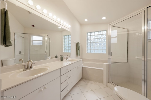 full bathroom with tile patterned flooring, a sink, toilet, and double vanity