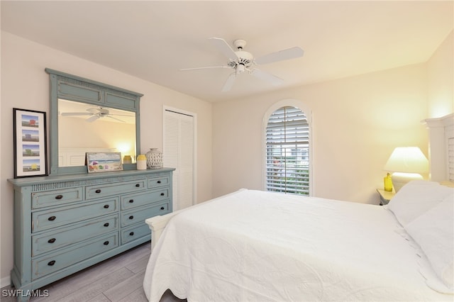 bedroom with light wood-type flooring and a ceiling fan